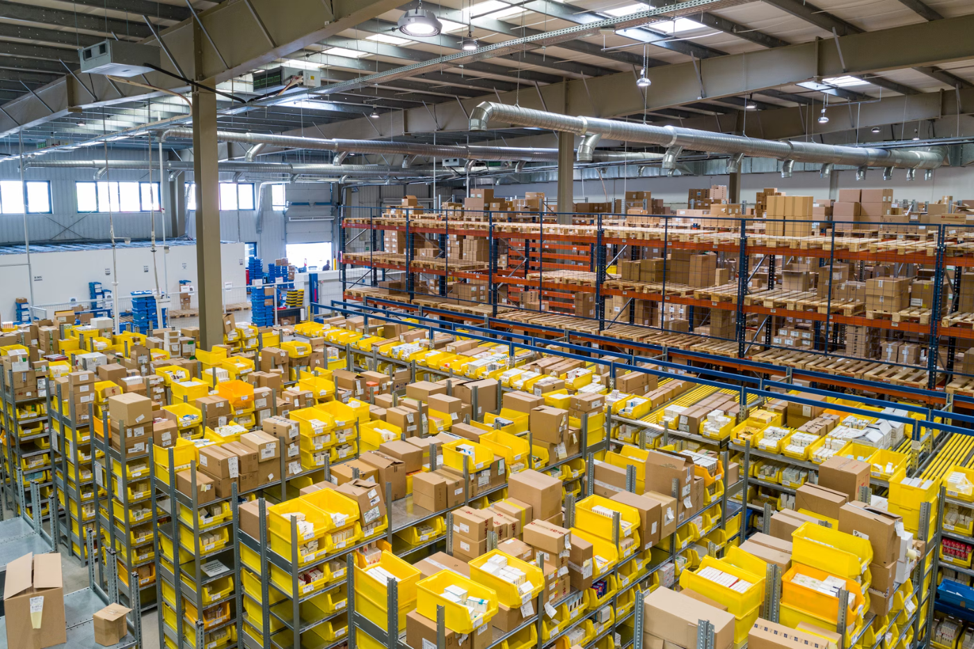 Cargo warehouse with stacked shipping containers and boxes at a warehouse distribution centre.