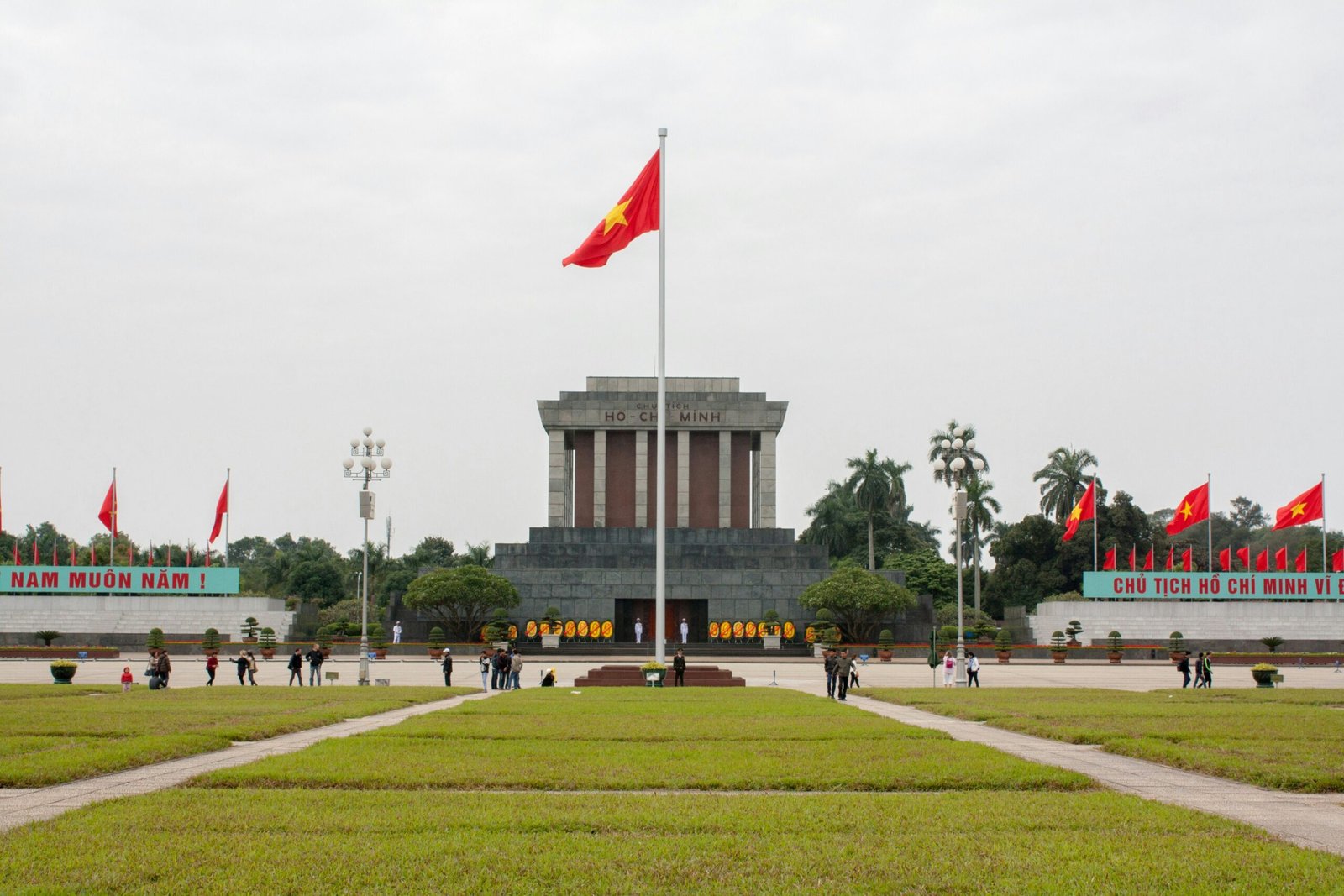 Flag of Vietnam waving at Hanoi Ho Chi Minh's building.