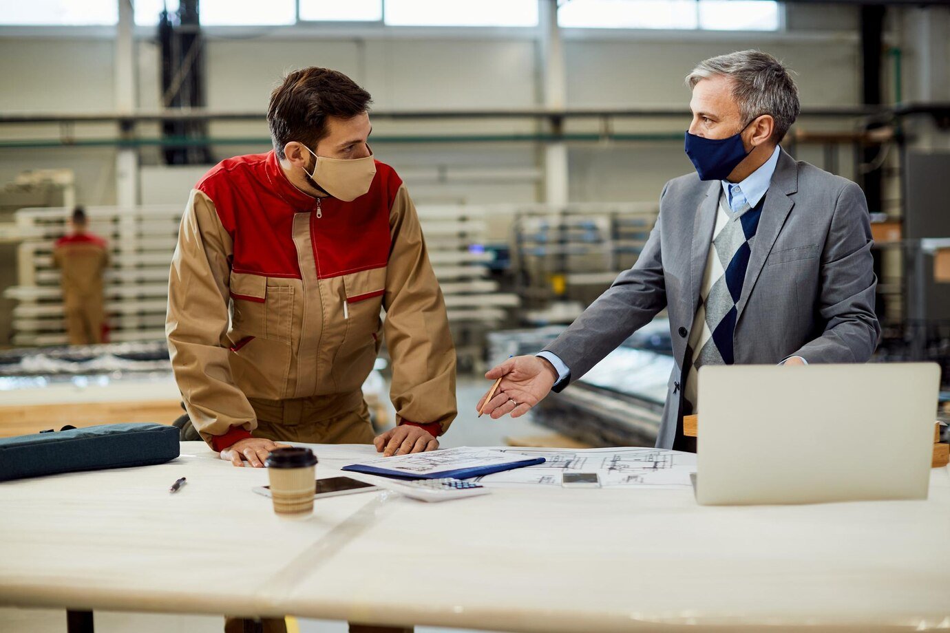 Project manager discussing contract manufacturing details with factory team
