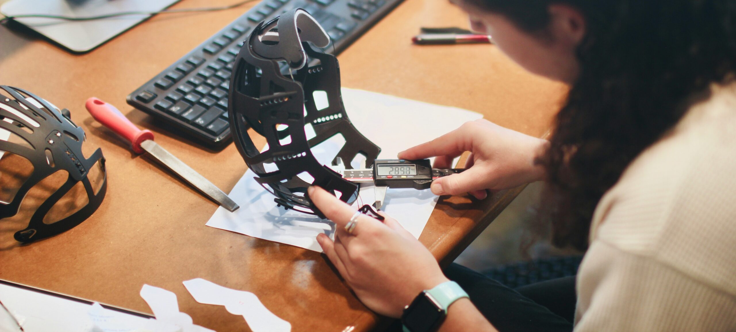 Quality control inspector measuring furniture dimensions with digital caliper
